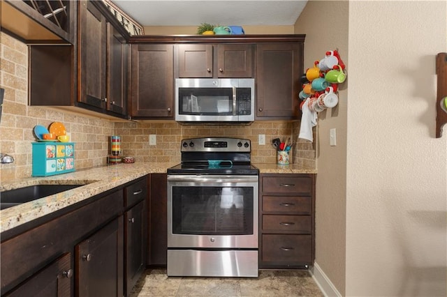 kitchen with decorative backsplash, dark brown cabinets, and appliances with stainless steel finishes