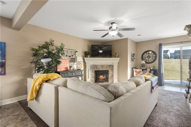 carpeted living room featuring a fireplace, beamed ceiling, and ceiling fan