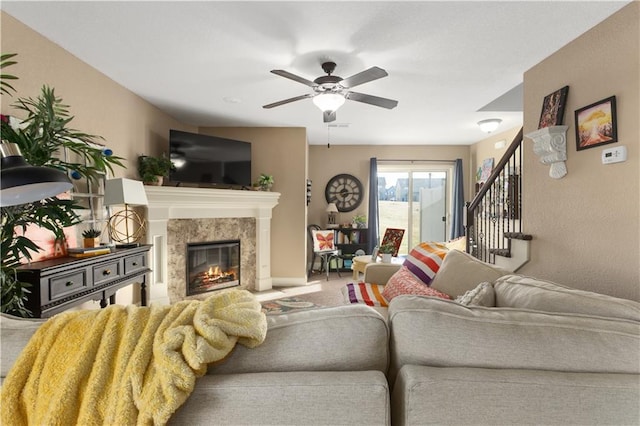 living room featuring ceiling fan, a fireplace, and carpet flooring