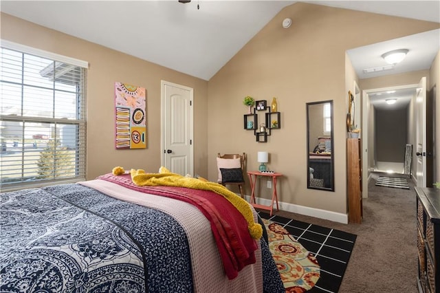 bedroom with vaulted ceiling and dark carpet