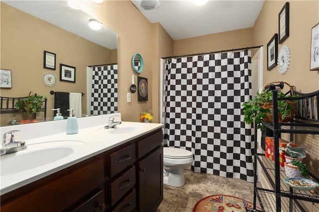 bathroom featuring a shower with curtain, vanity, and toilet