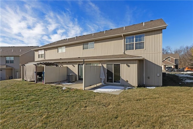 back of property with a patio area and a lawn