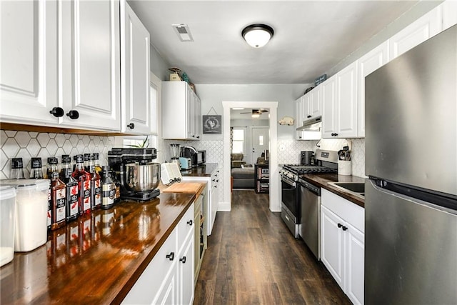 kitchen featuring butcher block countertops, ceiling fan, white cabinets, and appliances with stainless steel finishes