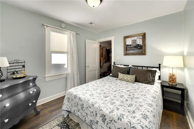 bedroom with dark wood-type flooring