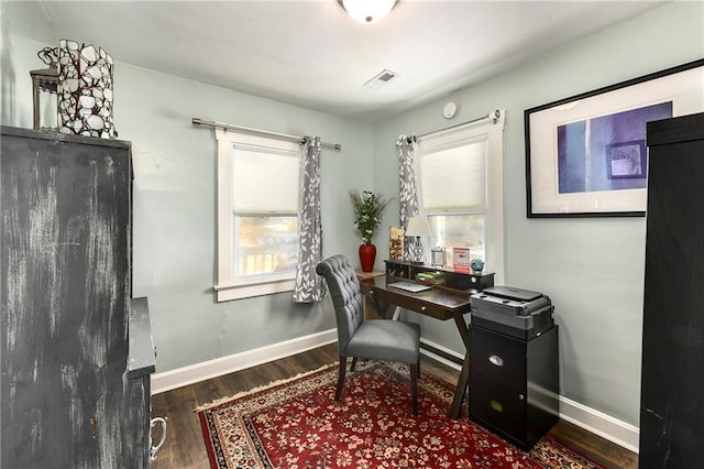 home office with dark hardwood / wood-style floors