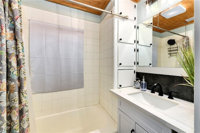 bathroom with tasteful backsplash, vanity, and shower / tub combo with curtain