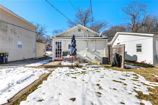 snow covered house with a wooden deck