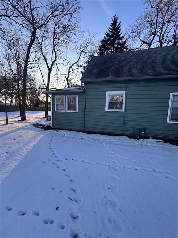 view of snow covered rear of property