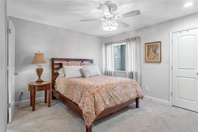 bedroom featuring light carpet and ceiling fan