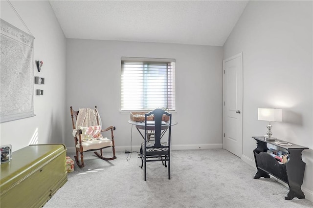 sitting room featuring light colored carpet and lofted ceiling