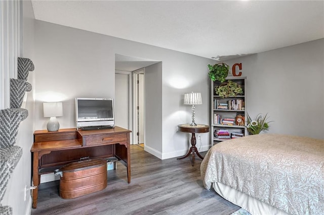 bedroom with hardwood / wood-style flooring