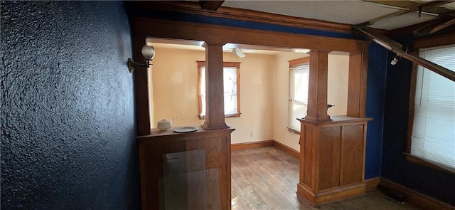 interior details featuring hardwood / wood-style floors and decorative columns