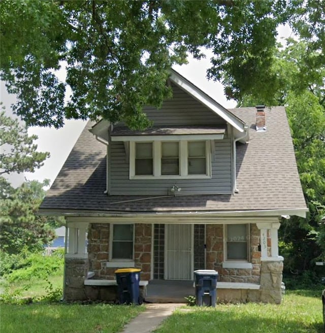 view of front of home with a porch and a front yard