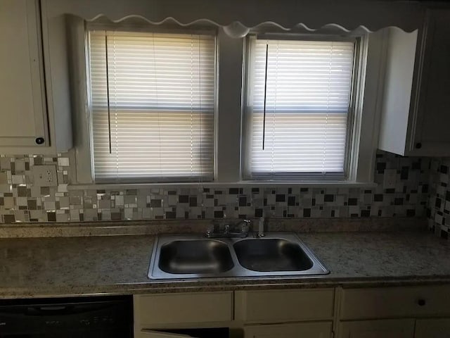 kitchen with dishwasher, sink, and backsplash