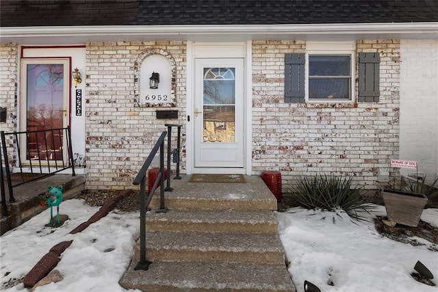 view of snow covered property entrance