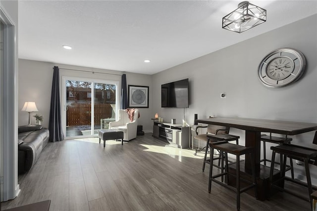 living room with hardwood / wood-style floors and a notable chandelier