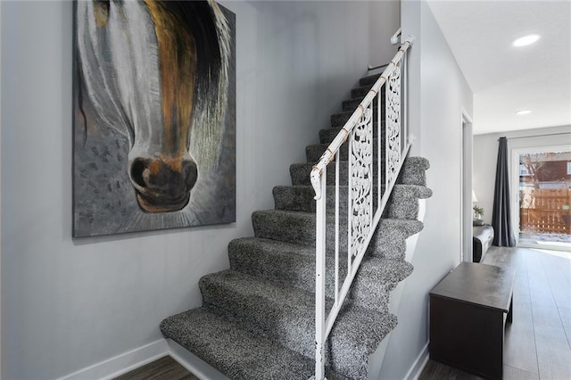 staircase with hardwood / wood-style flooring