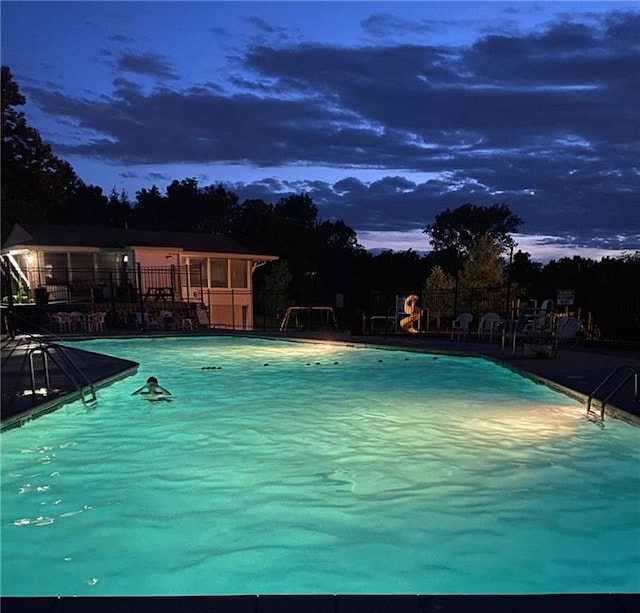 view of pool at dusk