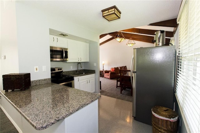 kitchen with appliances with stainless steel finishes, sink, white cabinets, and kitchen peninsula