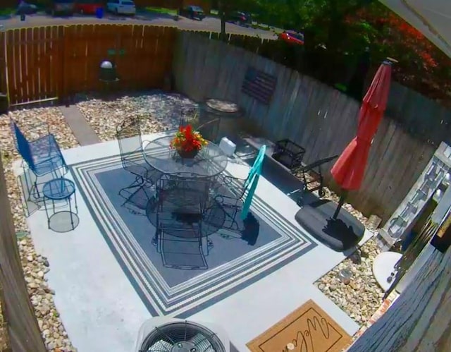 exterior space featuring outdoor dining space and a fenced backyard