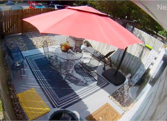 view of swimming pool featuring outdoor dining area and fence