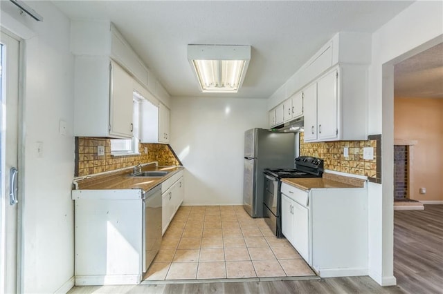 kitchen featuring sink, light hardwood / wood-style flooring, stainless steel appliances, tasteful backsplash, and white cabinets