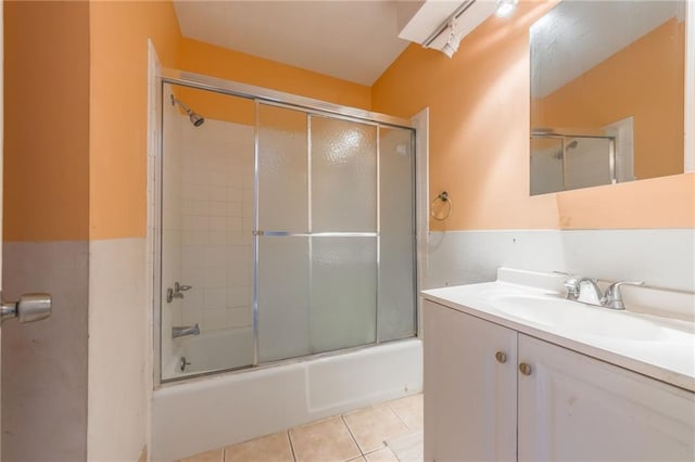 bathroom with bath / shower combo with glass door, tile patterned floors, and vanity