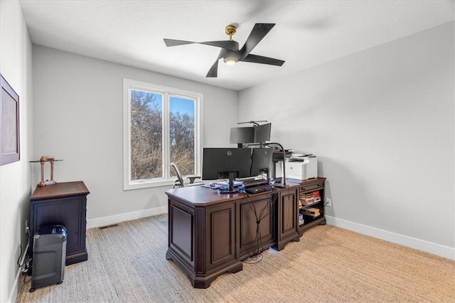 carpeted office space with ceiling fan