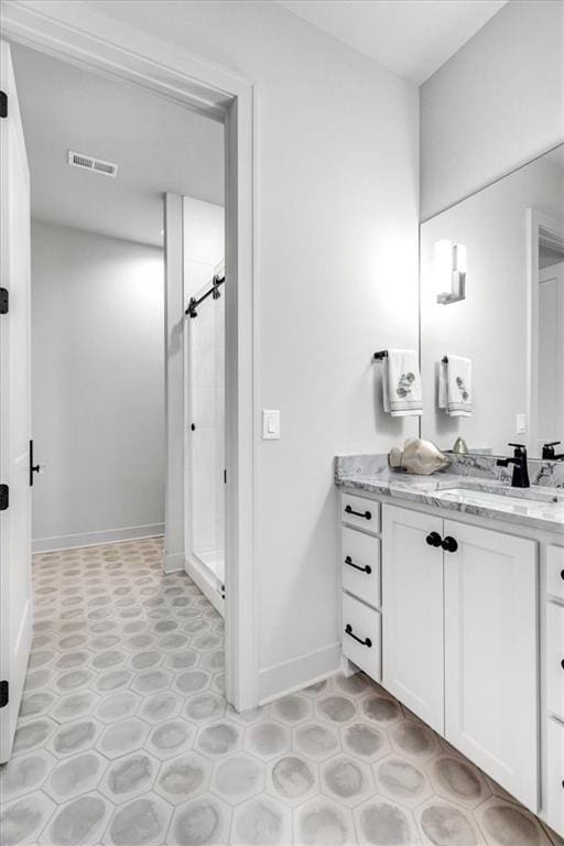 bathroom featuring vanity and a shower with shower door