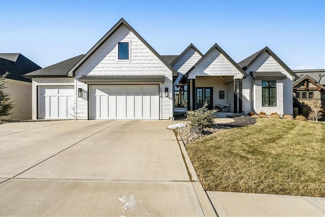 view of front of property featuring a garage and a front yard