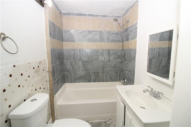 809 S 19th St, Saint Joseph, MO 64507 - full bathroom featuring tile walls, toilet, vanity, and shower / bath combination