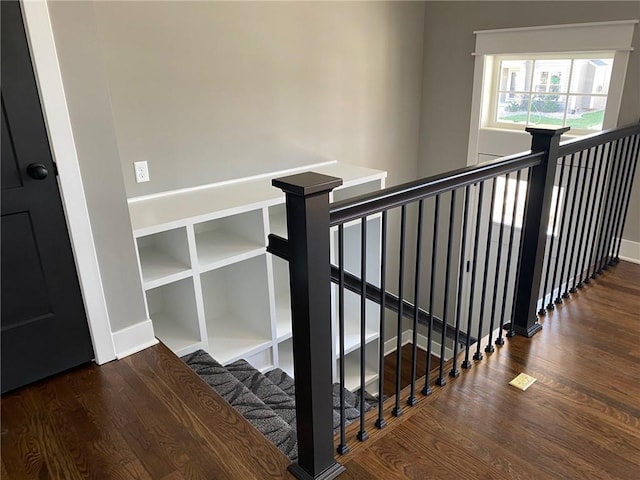 stairway with hardwood / wood-style floors