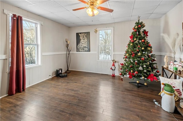 spare room featuring ceiling fan, dark hardwood / wood-style floors, and a drop ceiling