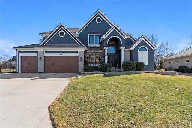 view of front of house with a garage, concrete driveway, and a front lawn