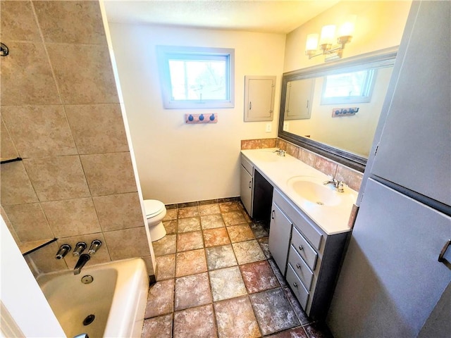 bathroom featuring vanity, a bathtub, and toilet