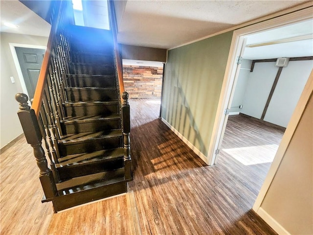 stairs featuring hardwood / wood-style flooring