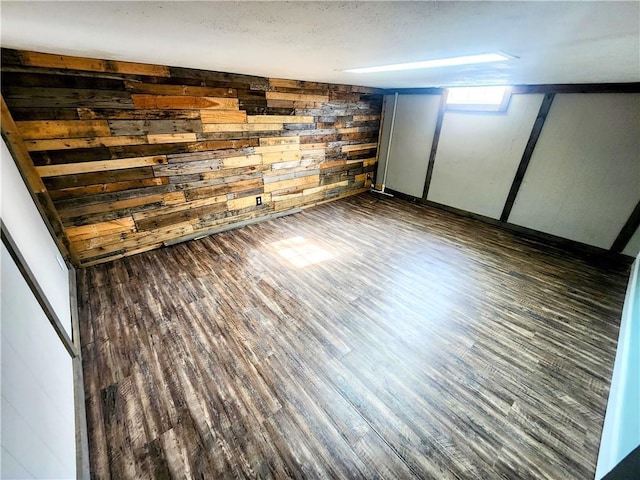 interior space featuring dark hardwood / wood-style flooring and wooden walls