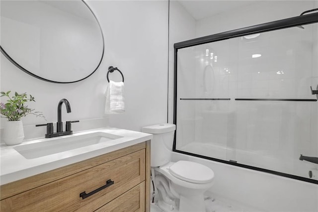 full bathroom featuring shower / bath combination with glass door, vanity, and toilet