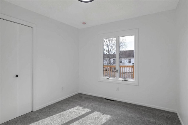 unfurnished bedroom featuring carpet flooring and a closet