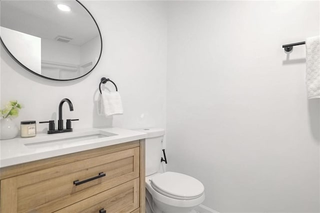 bathroom featuring vanity and toilet