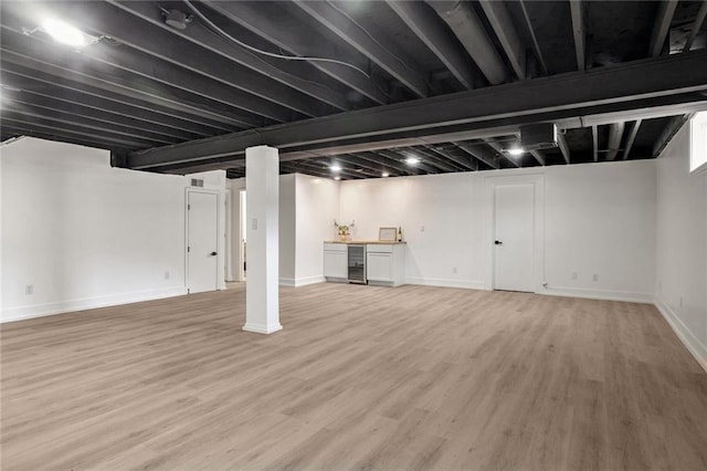 basement with light hardwood / wood-style floors