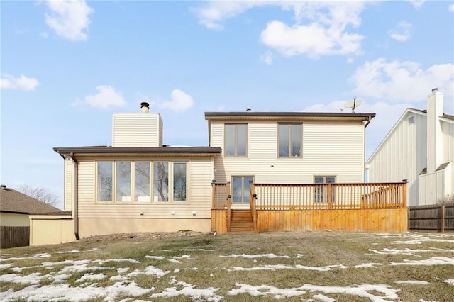 snow covered property with a deck