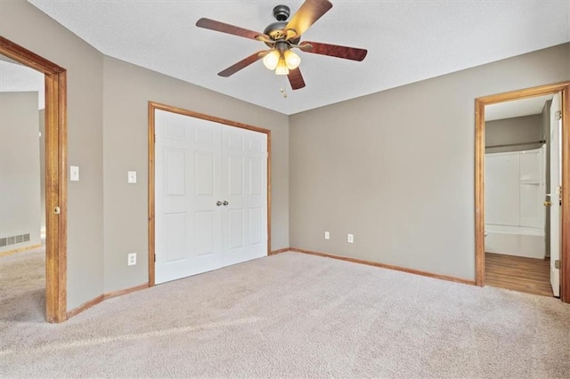 unfurnished bedroom featuring ceiling fan, carpet flooring, and a closet