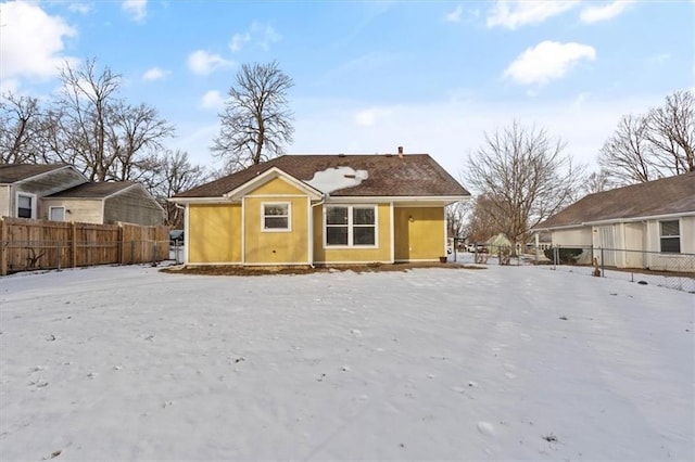 view of snow covered rear of property