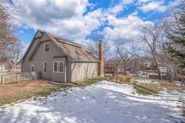 view of snowy exterior with a deck