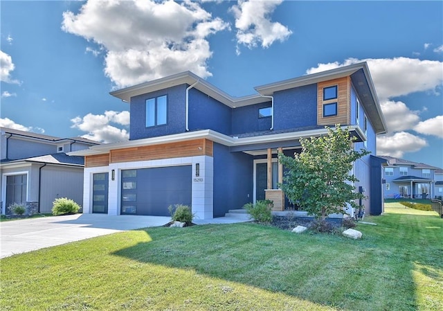 contemporary house featuring a garage and a front lawn