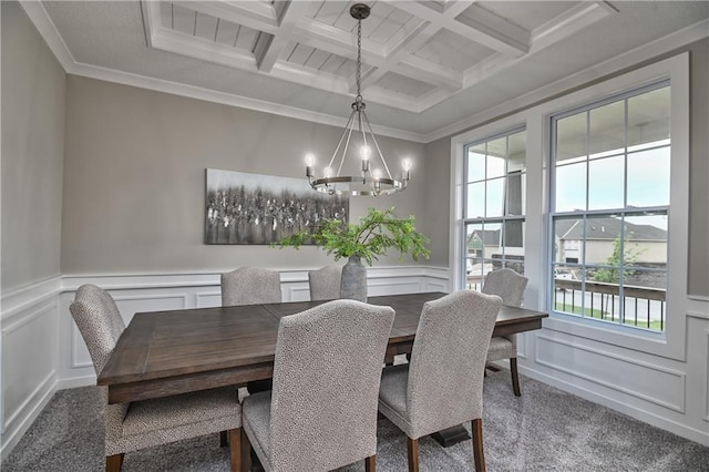 carpeted dining area featuring beamed ceiling, ornamental molding, coffered ceiling, and an inviting chandelier