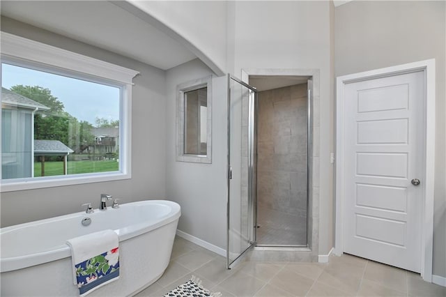 bathroom featuring shower with separate bathtub and tile patterned flooring