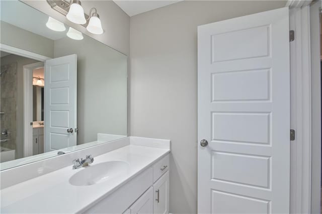 bathroom featuring tiled shower / bath combo and vanity