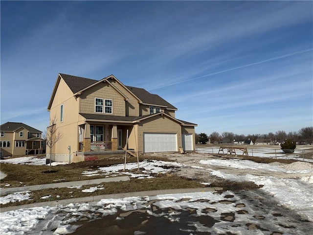 view of front of property featuring a garage and covered porch